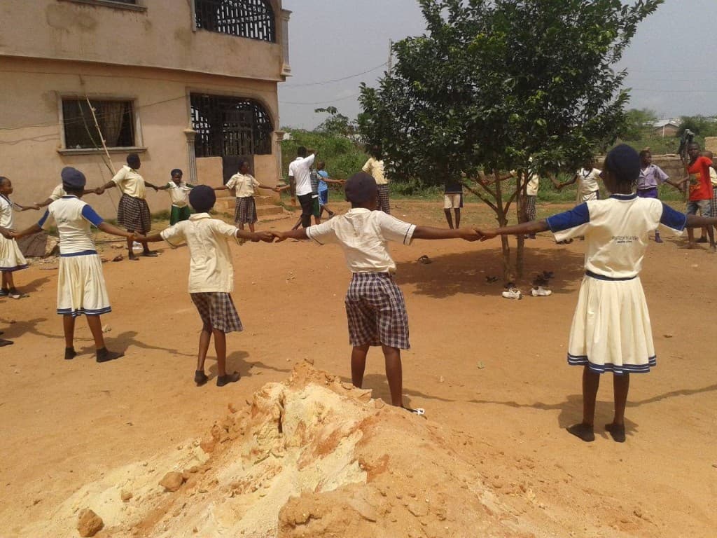 Fortress Academy students gathered in a circle on campus