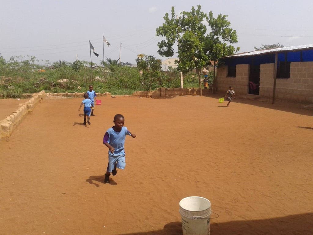 Students running across the Fortress Academy courtyard