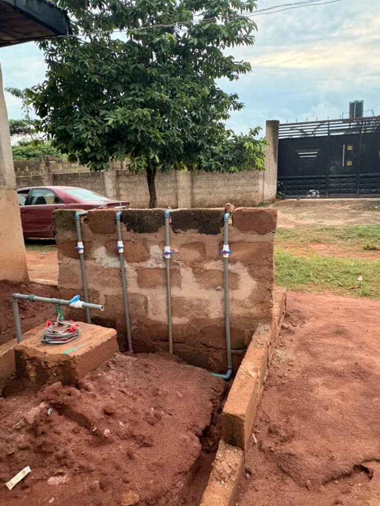 PVC distribution pipes and blue valves at the Fortress Academy tap wall