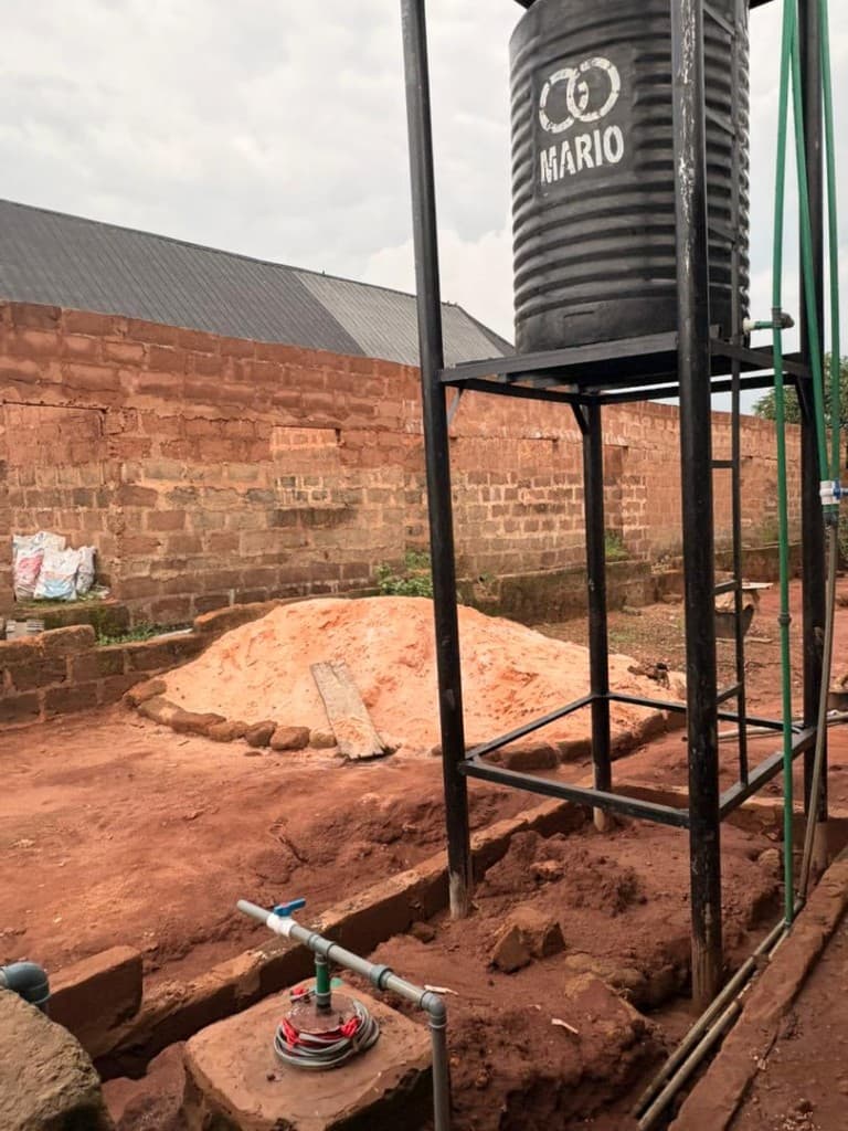 Borehole wellhead and elevated MARIO storage tank on campus